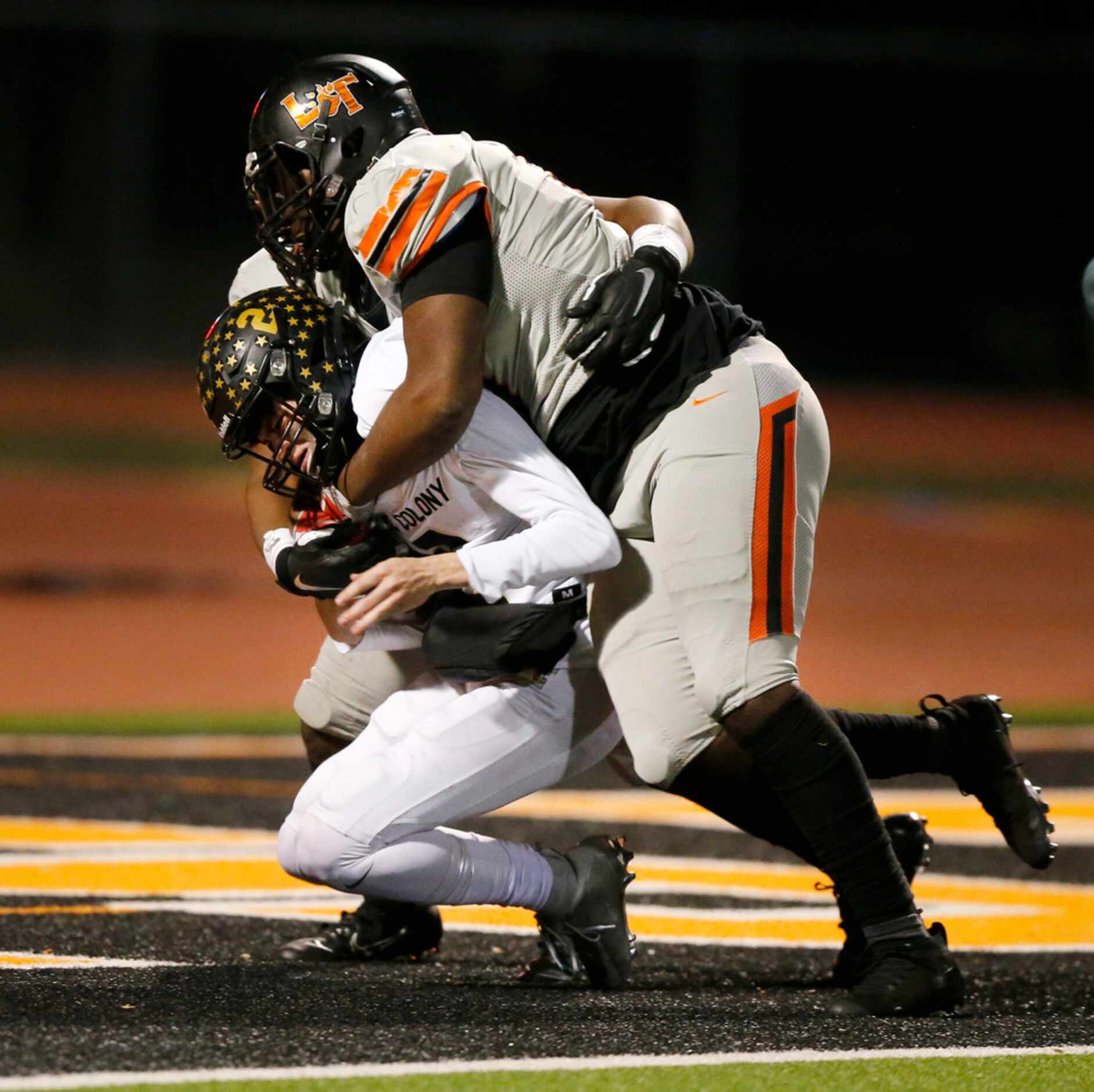 Lancaster defensive linemen Tray Newton and Waymon Smith (behind) sack The Colony...