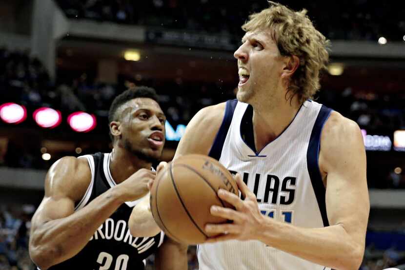 Dallas Mavericks forward Dirk Nowitzki (41) fights off Brooklyn Nets forward Thaddeus Young...