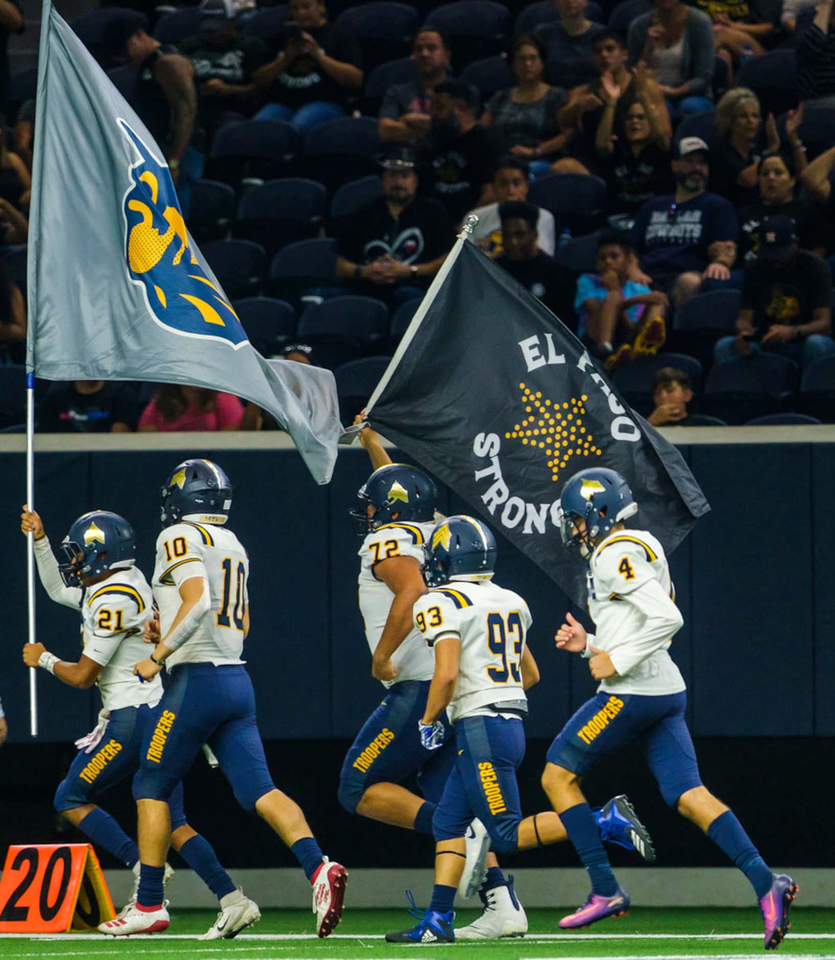 El Paso Eastwood players take the field for the second half of a high school football game...
