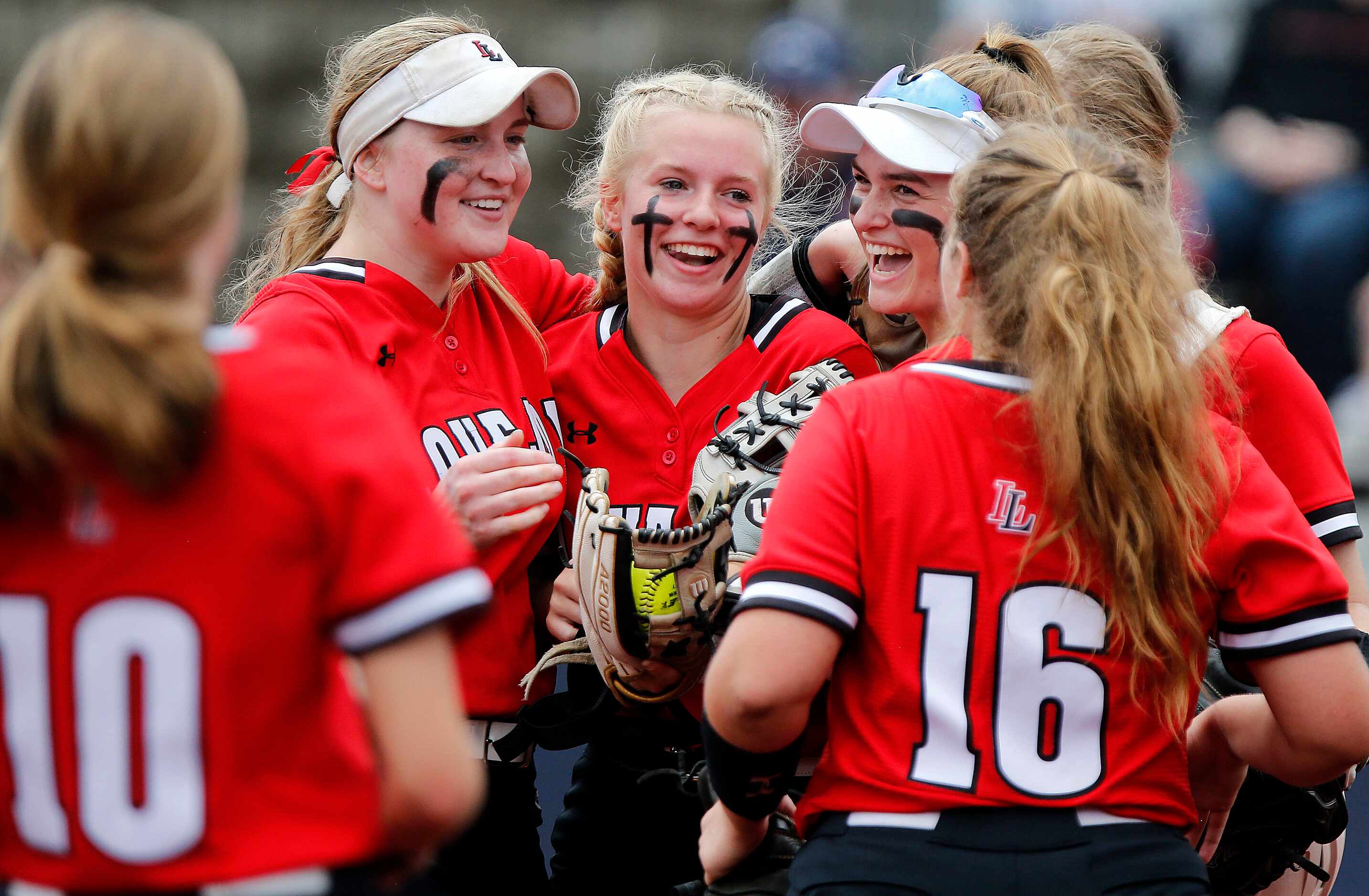 Lovejoy pitcher Jade Owens (center) is congratulated by her team after getting out of a jam...