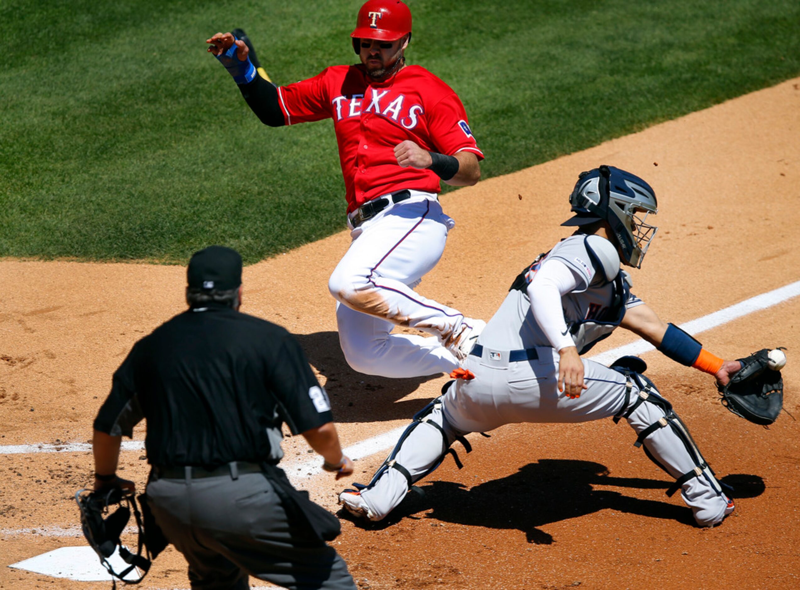 Texas Rangers left fielder Joey Gallo (13) slides safely into home plate as Houston Astros...