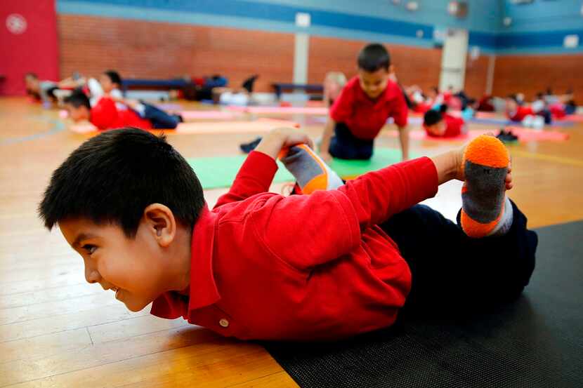  Dallas Morning News file photo by Tom Fox of students trying yoga at recess. 