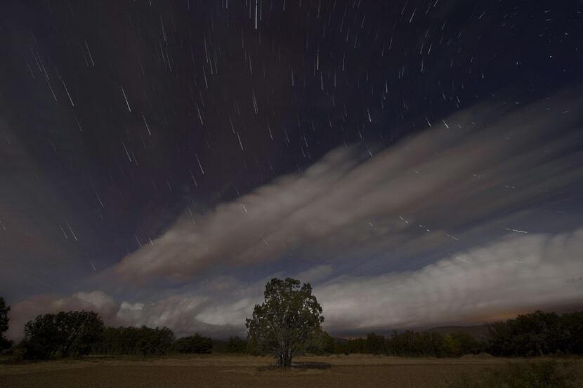A multiple exposure picture taken in the early hours of August 12, 2014 shows a Perseids...