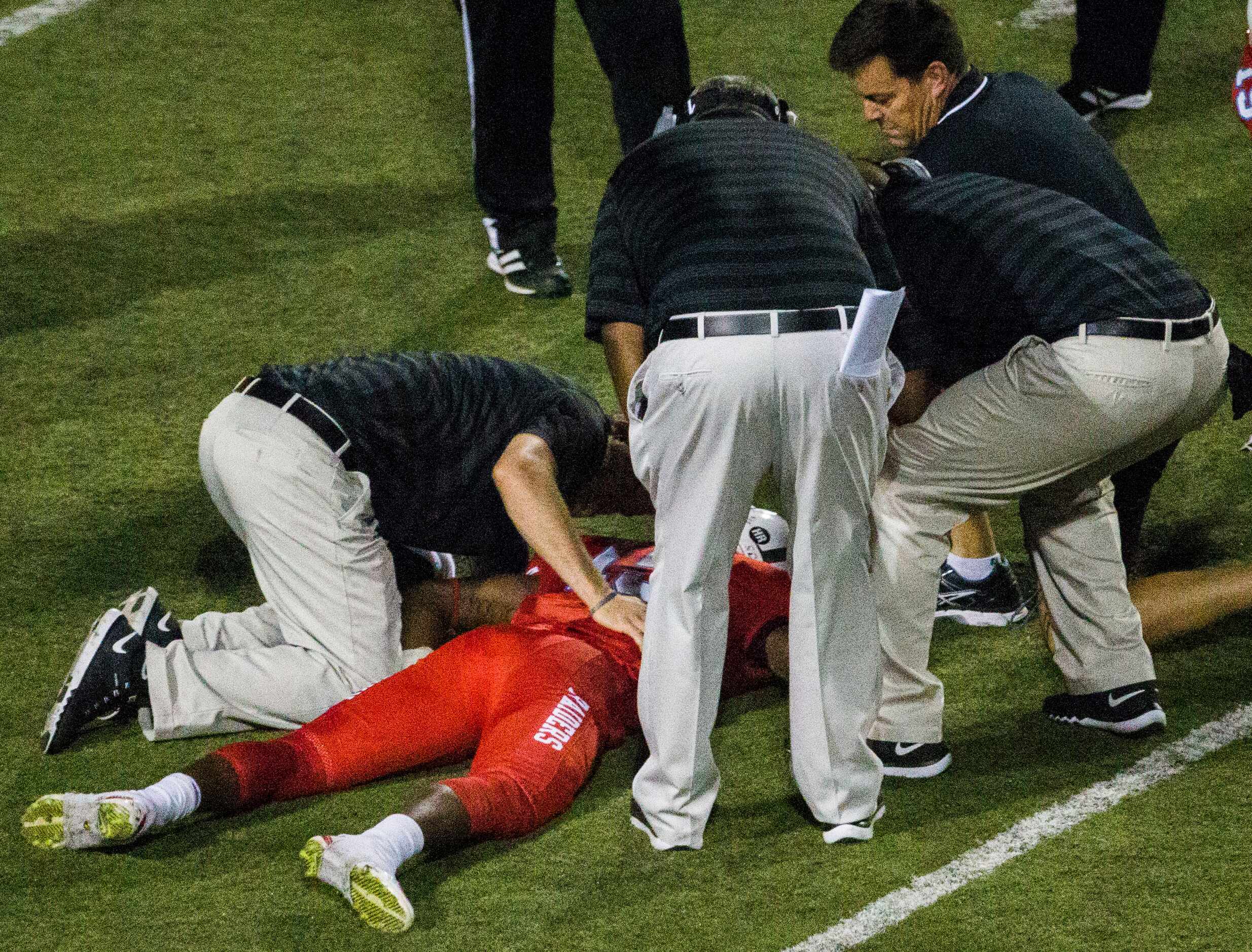 Skyline wide receiver LaDavion Washington (15) lays unconscious on the field after a hit...