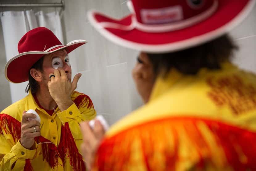 Barrel man John Harrison gets dressed during the sixth night of the National Finals Rodeo at...