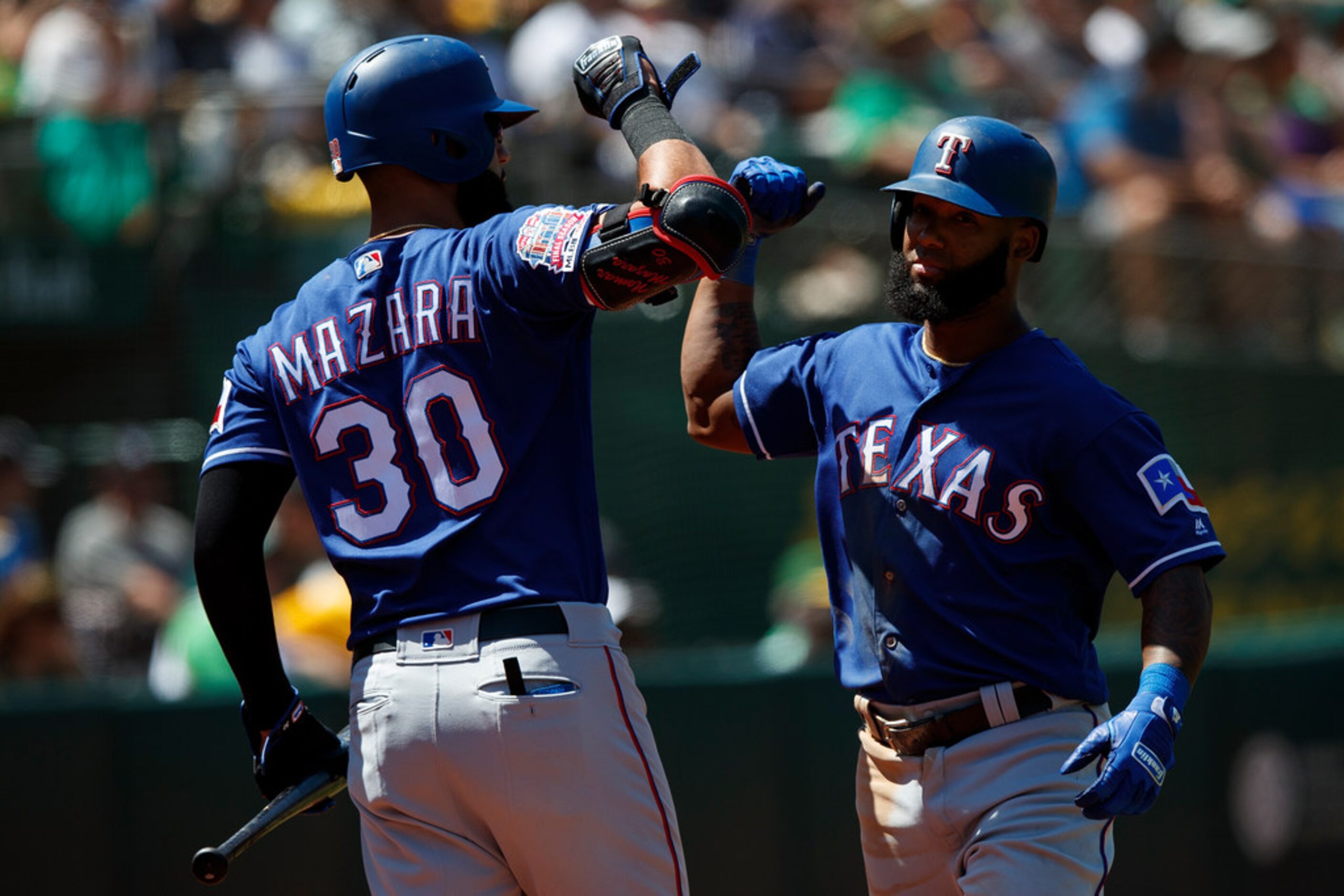 OAKLAND, CA - JULY 28:  Danny Santana #38 of the Texas Rangers is congratulated by Nomar...