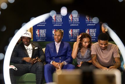 Surrounded by family, Jahmi?us Ramsey (second from left) sits with his dad Avery (left), mom...