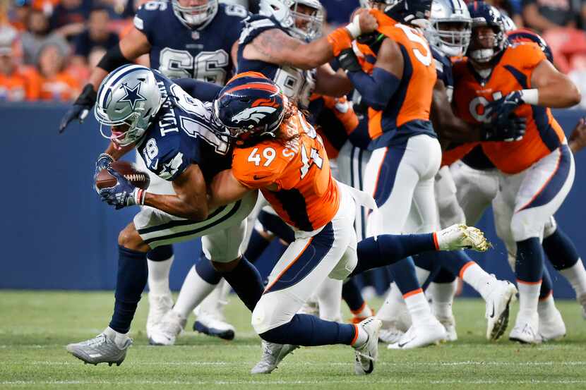 Denver Broncos linebacker Alex Singleton (49) brings down Dallas Cowboys wide receiver Jalen...
