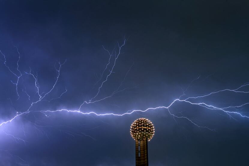 A file photo of lightning across the sky behind the Reunion Tower Ball in downtown Dallas,...