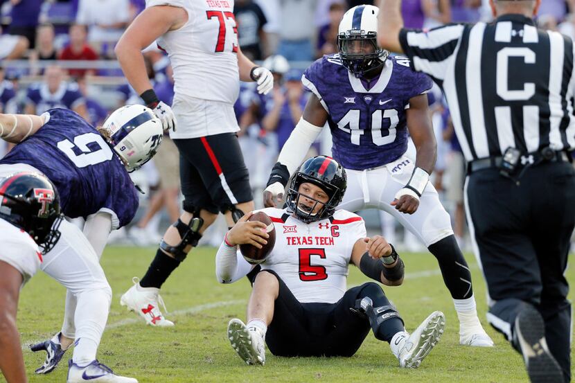 Texas Tech quarterback Patrick Mahomes II (5) sits on the ground after being sacked by TCU...