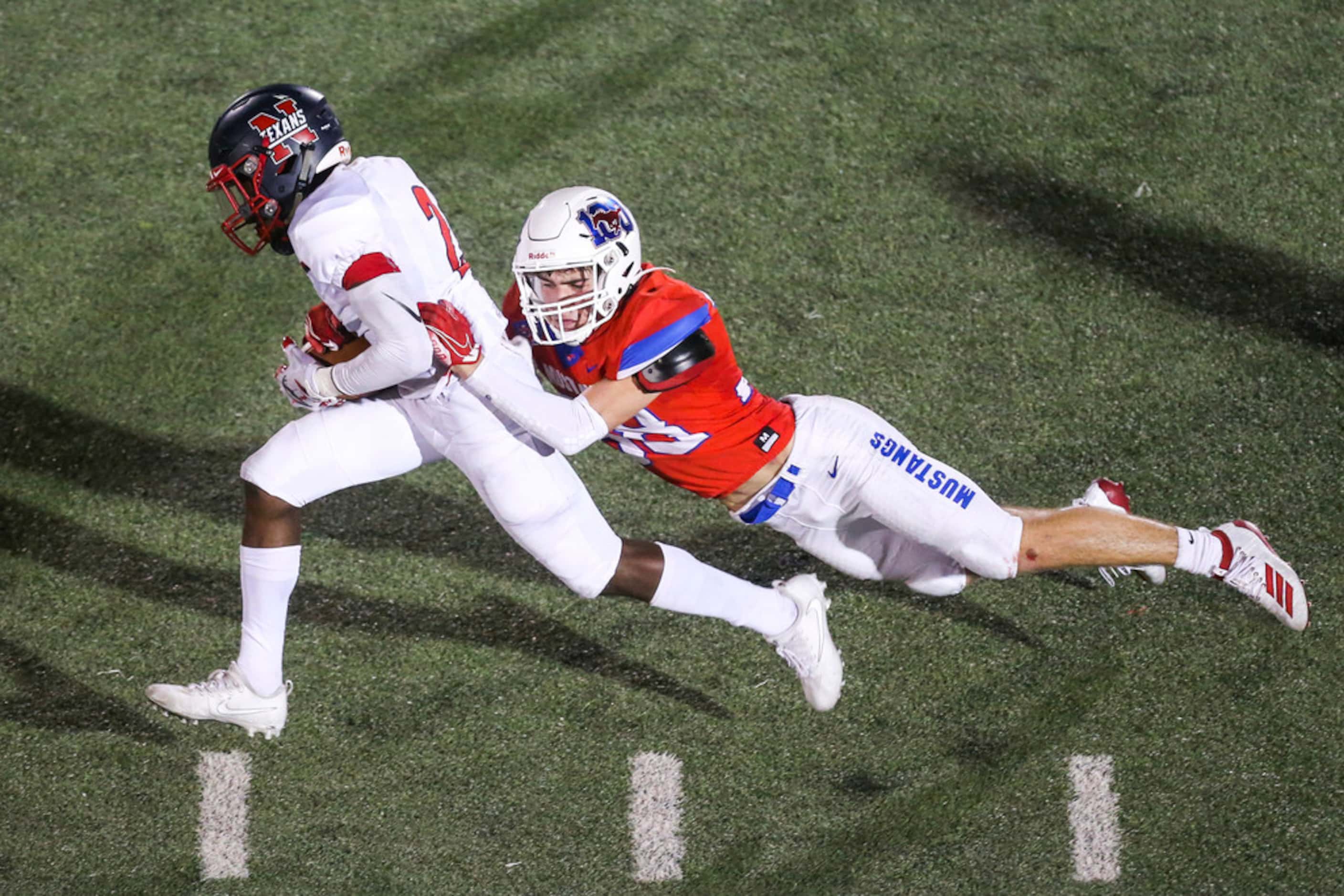 Northwest's Zavion Taylor (2) carries the ball as he is brought down by Grapevine defensive...