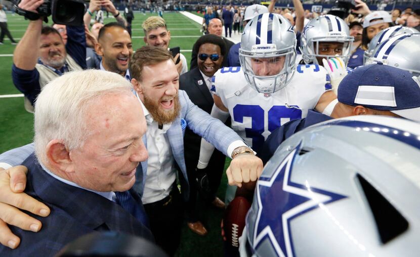 Dallas Cowboys owner Jerry Jones (left) and MMA fighter Conor McGregor of Ireland (center)...