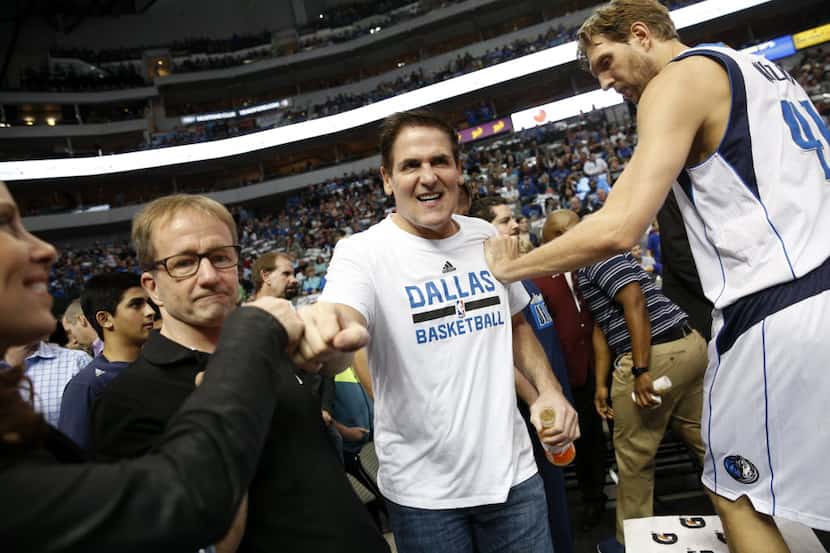 Dallas Mavericks owner Mark Cuban fist bumps fans before a game against the Minnesota...