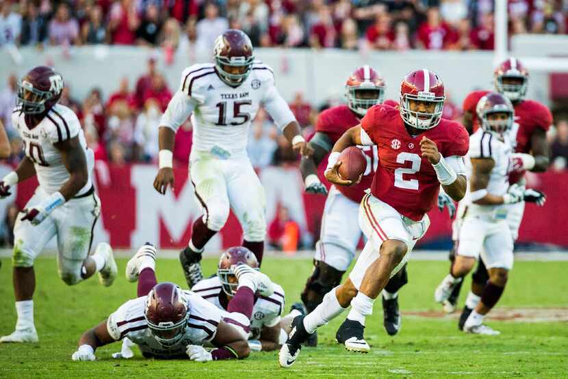 Alabama quarterback Jalen Hurts (2) breaks through the Texas A&M defense on a 37-yard...