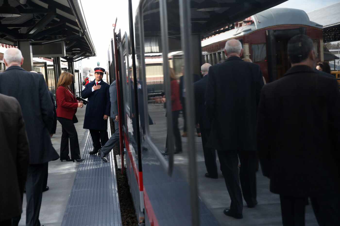 Daniel Jiminez, conductor, greets people Monday as they board the Trinity Metro TEXRail  at...