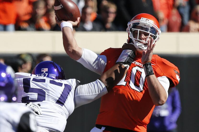 Oklahoma State head coach Mike Gundy elected to bench starter J.W. Walsh for Clint Chelf....