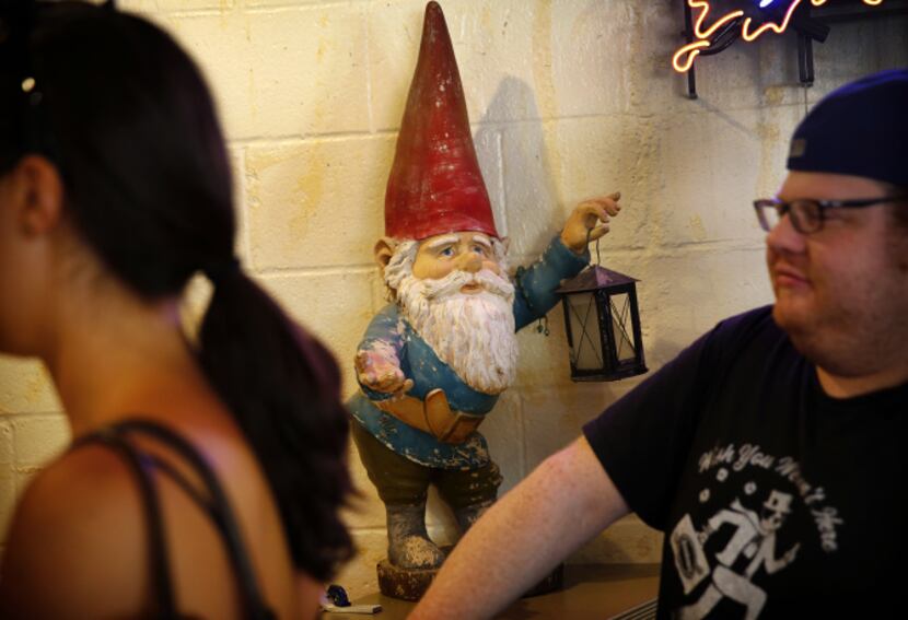 Franklin Barbecue's gnome that once stood outside the original trailer along I-35 greets...