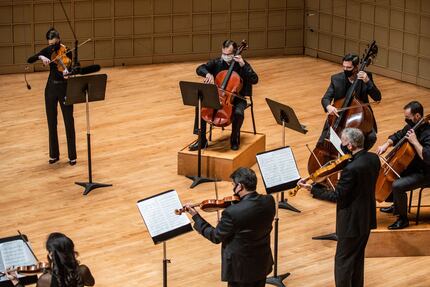 Members of the Dallas Symphony Orchestra perform 'Last Round' by Osvaldo Golijov as part of...