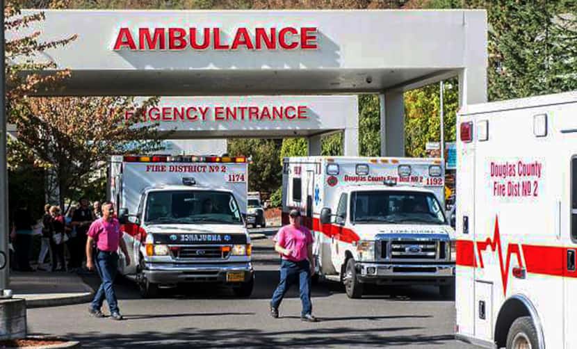 Paramedics return to their ambulances Thursday after delivering patients to Mercy Medical...