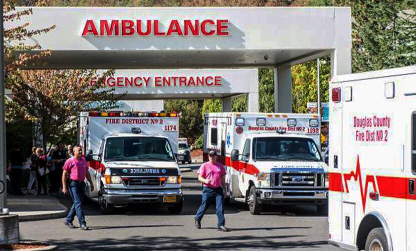 Paramedics return to their ambulances Thursday after delivering patients to Mercy Medical...