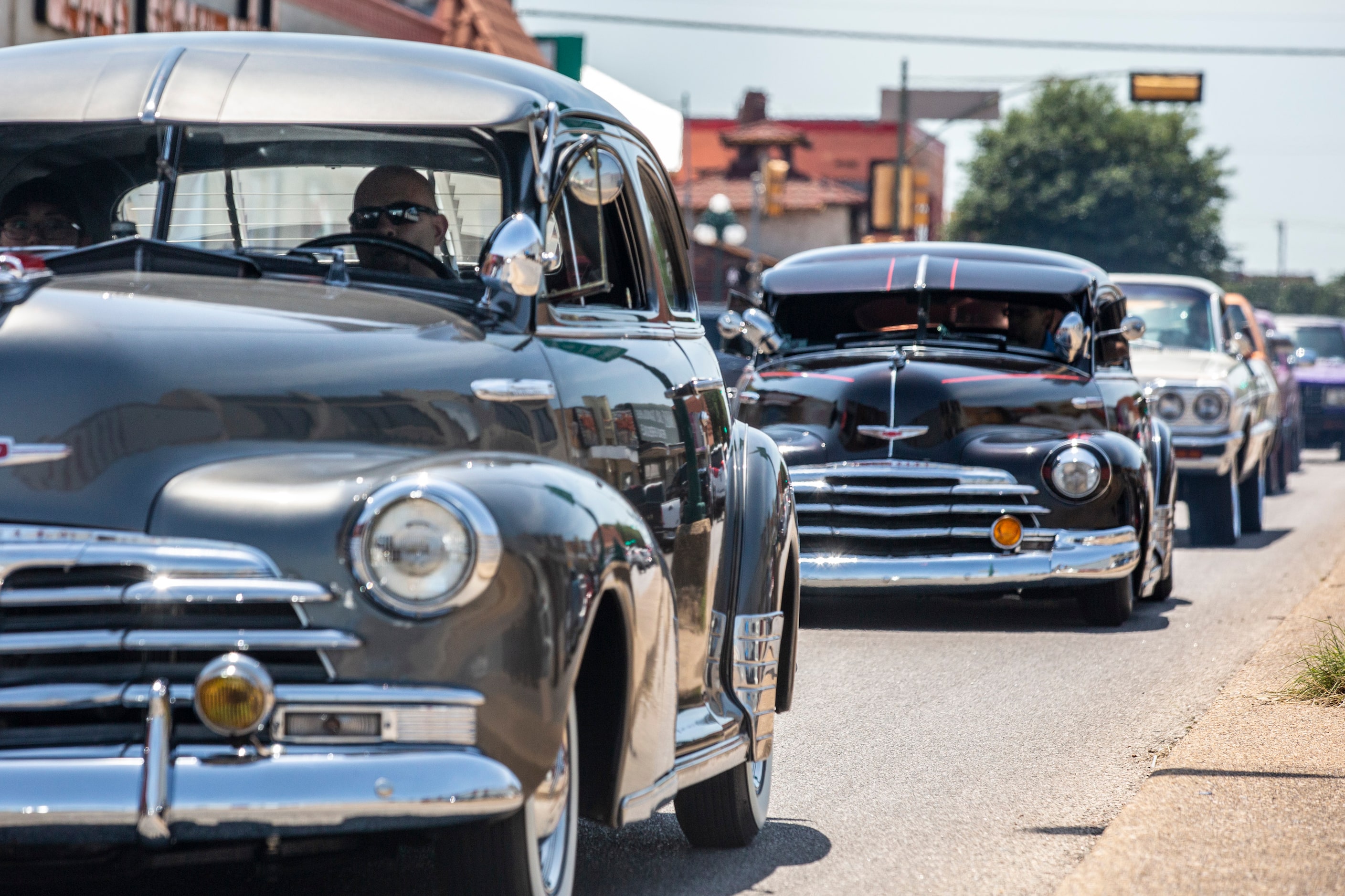 The United Lowriders Association of Dallas drive along the Jefferson Boulevard business...