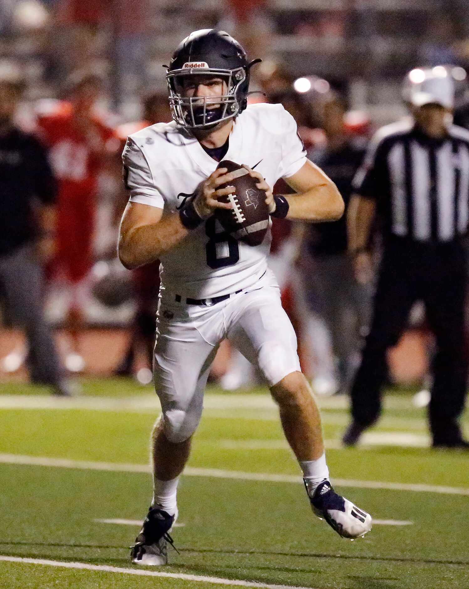 Flower Mound High School quarterback Yale Erdman (8) rolls out and kept the ball to score...