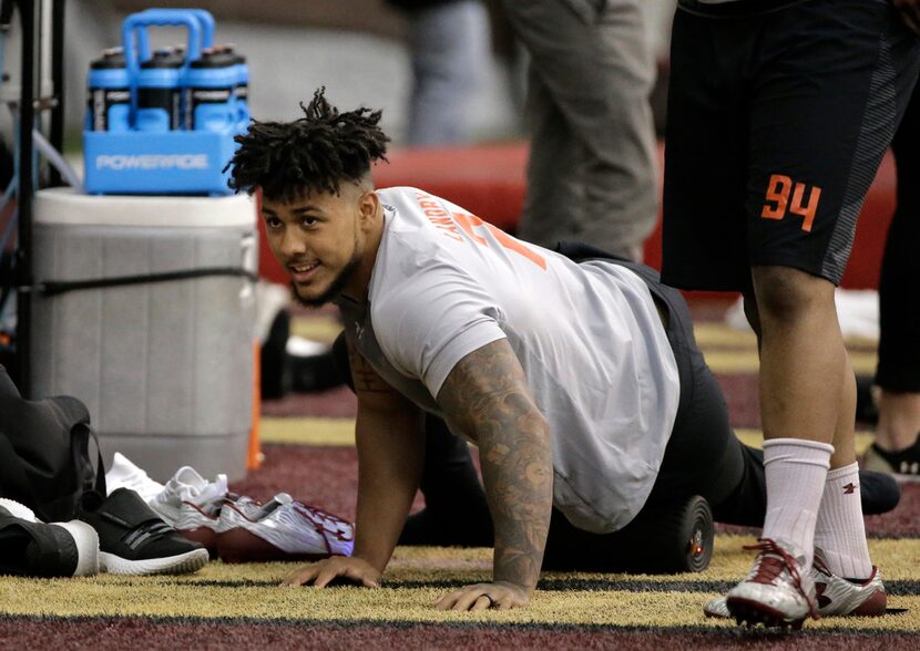 Boston College football defensive end Harold Landry uses a roller on his muscles during BC...