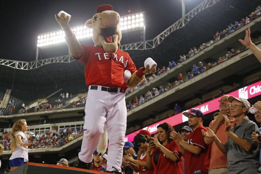 Rangers mascot "Captain" gets ready to distribute t-shirts during the seventh-inning stretch...