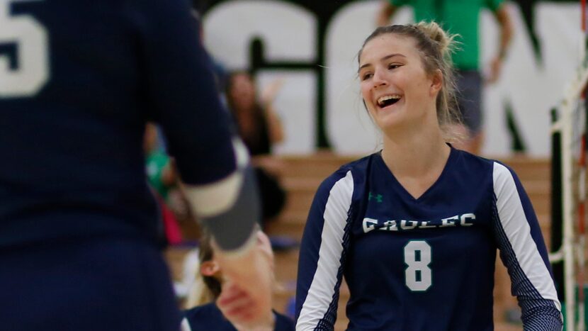 Northwest Eaton middle hitter Lindsey Harris (8), right, reacts after scoring with a block...