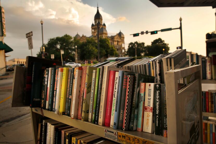 Books are for sale on the sidewalk outside Recycled Books at 200 N Locust  in downtown Denton.