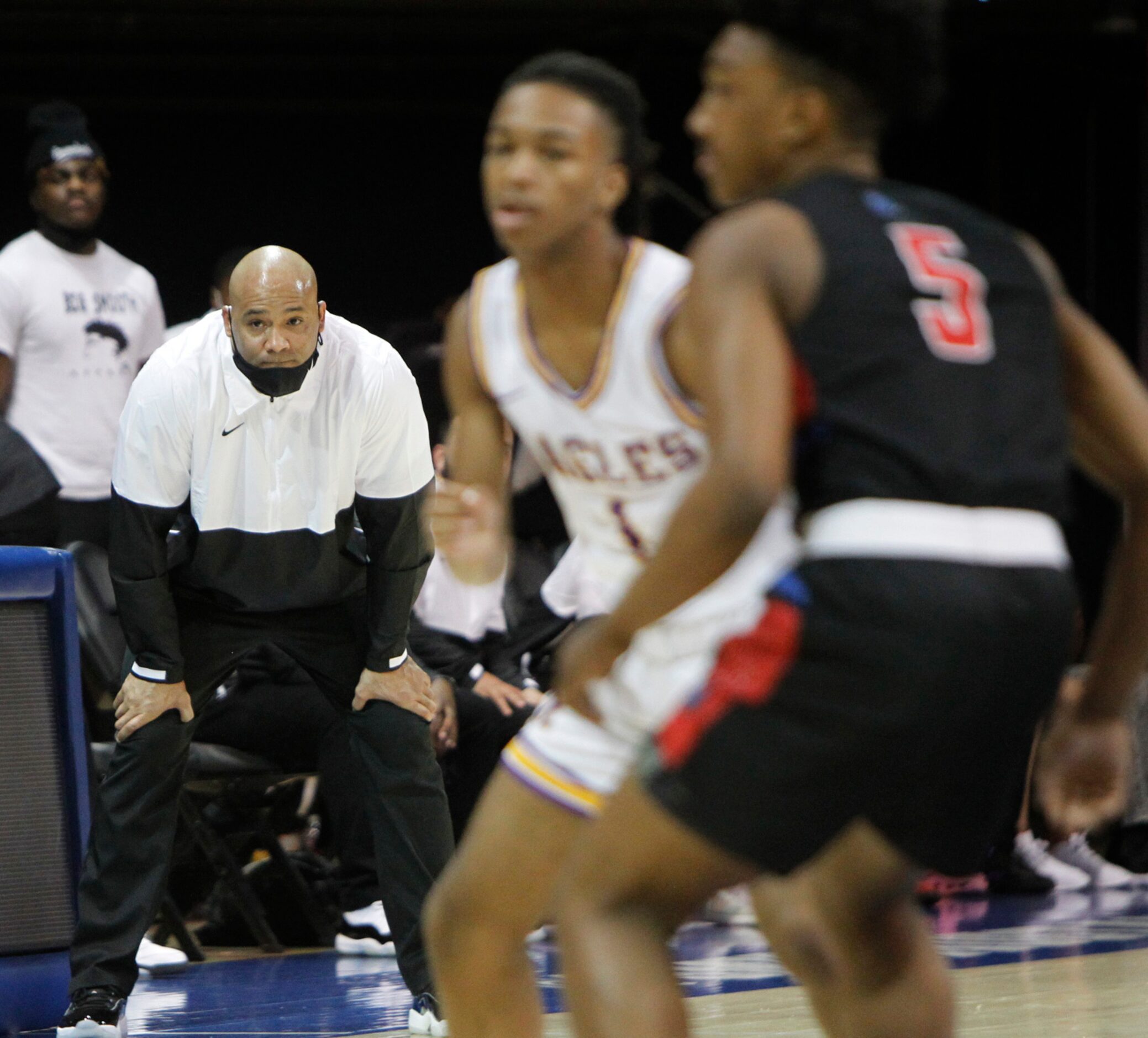 Duncanville head coach David Peavy intently follows the final minute of play in their 68-49...