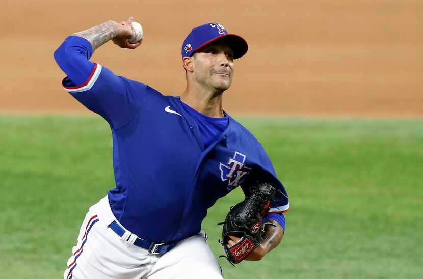 Texas Rangers relief​ pitcher Matt Bush throws against the Milwaukee Brewers in the eighth...
