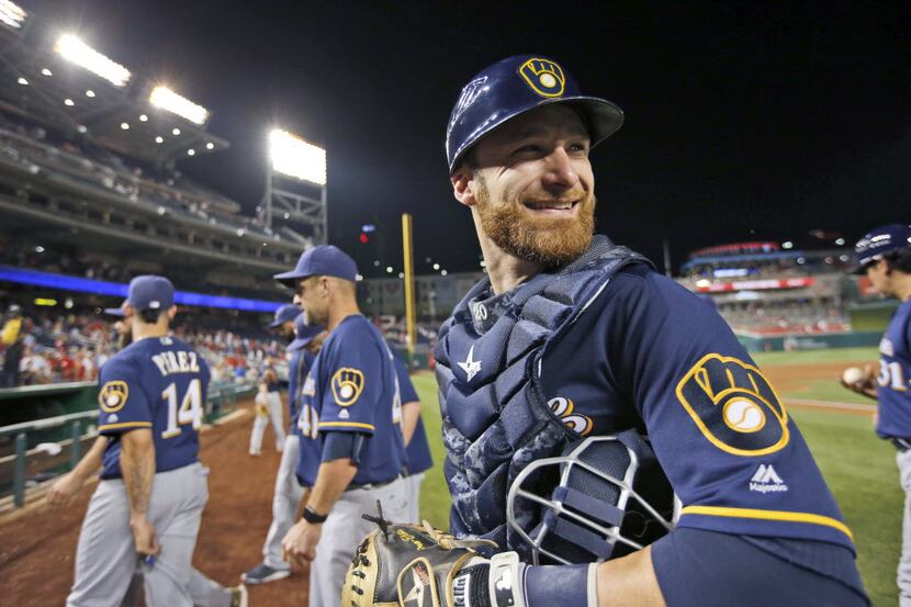 Milwaukee Brewers catcher Jonathan Lucroy smiles as he leaves the field after celebrating...