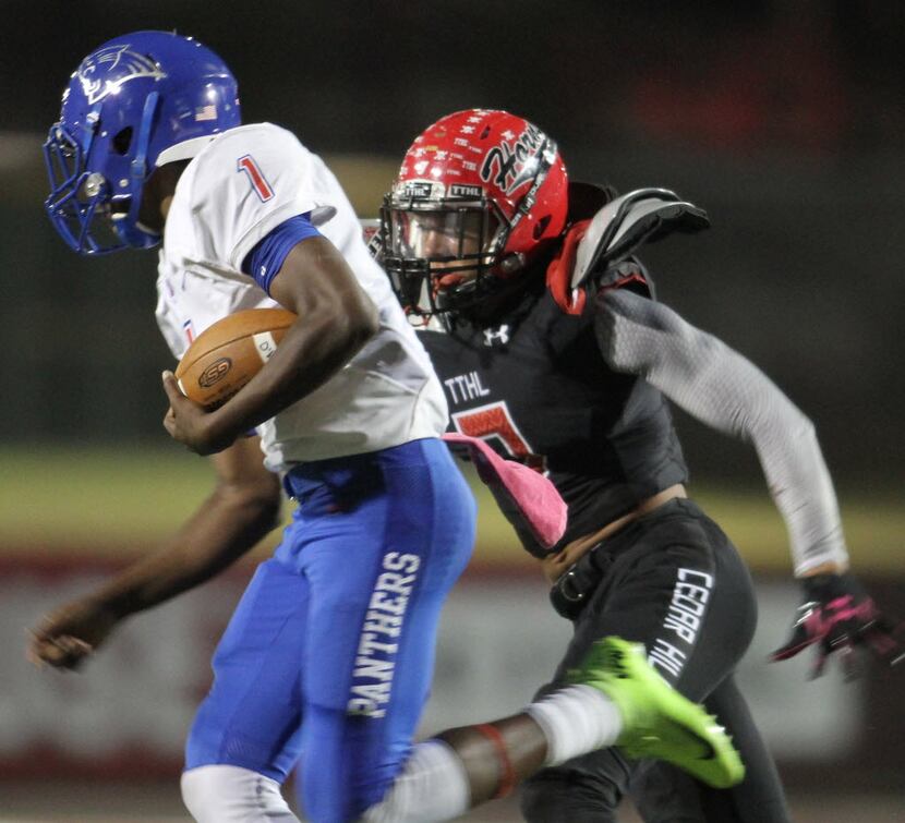 Duncanville quarterback Mike Myers (1) tries to elude the lateral pursuit of Cedar Hill...
