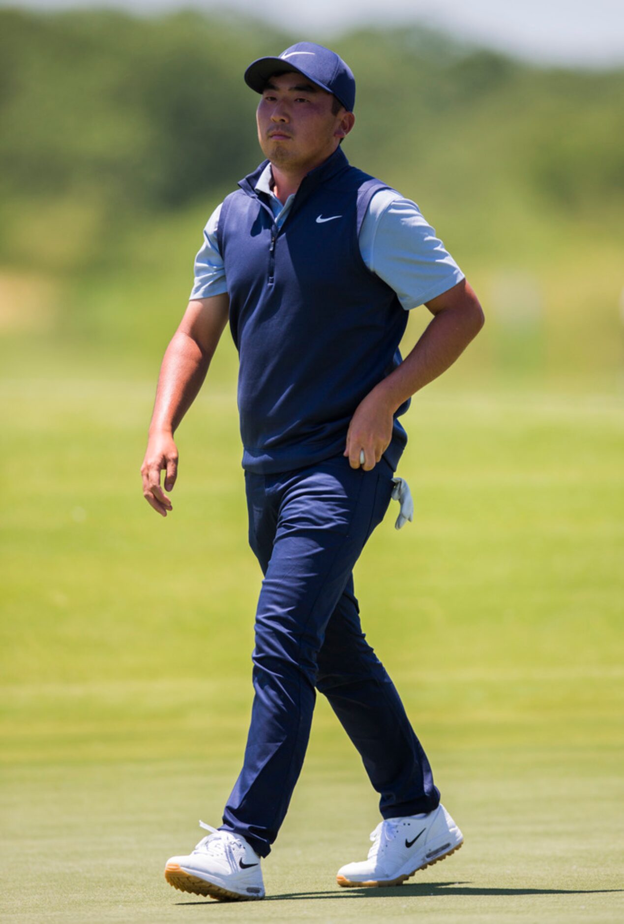 Doug Ghim putts walks to hole 4 during round 4 of the AT&T Byron Nelson golf tournament on...