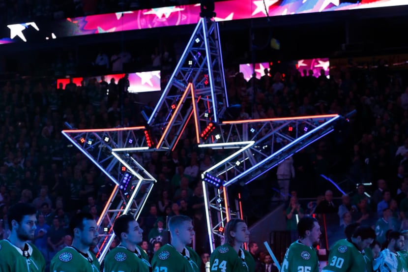 The Dallas Stars line up for the national anthem during their season-opening game against...