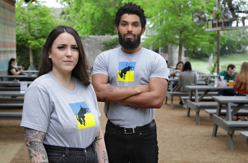 Britlyn Dalton, left, and Bryce Bennett pose for a photograph in their Ukranian-themed work...