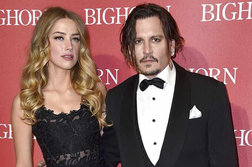 ARCHIVO – En esta fotografía del 2 de enero de 2016, Amber Heard y Johnny Depp durante un...
