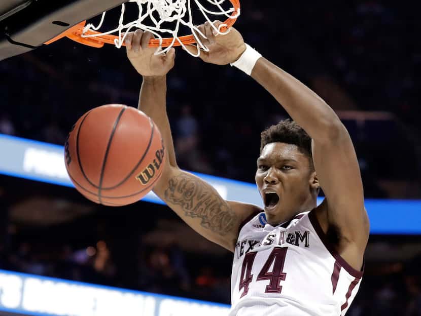 FILE - In this March 16, 2018, file photo, Texas A&M's Robert Williams dunks against...