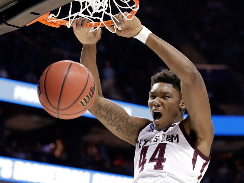 FILE - In this March 16, 2018, file photo, Texas A&M's Robert Williams dunks against...