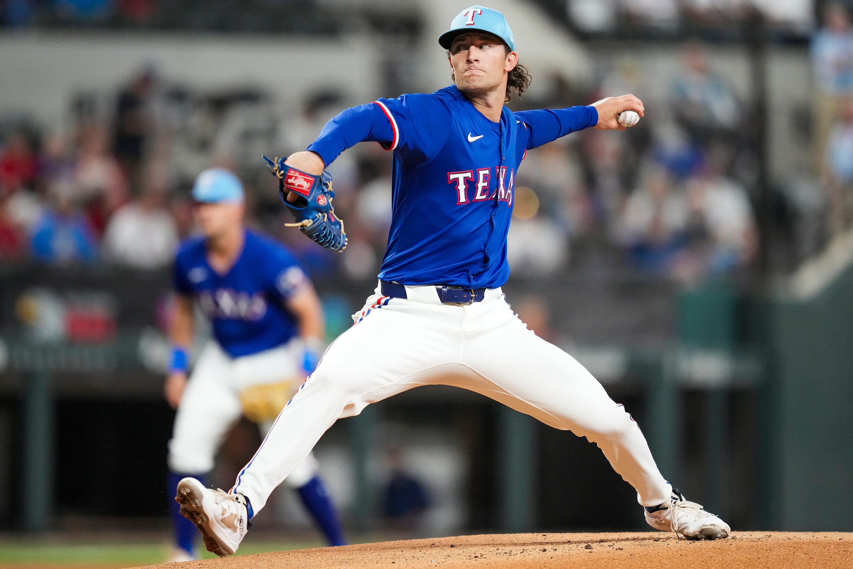 Texas Rangers pitcher Jake Latz delivers during the first inning of an exhibition baseball...