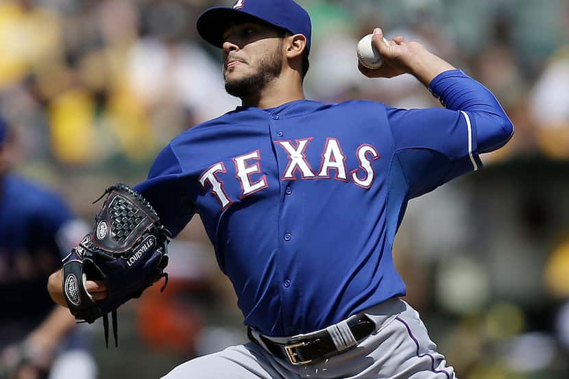 Texas Rangers' Martin Perez works against the Oakland Athletics in the first inning of a...