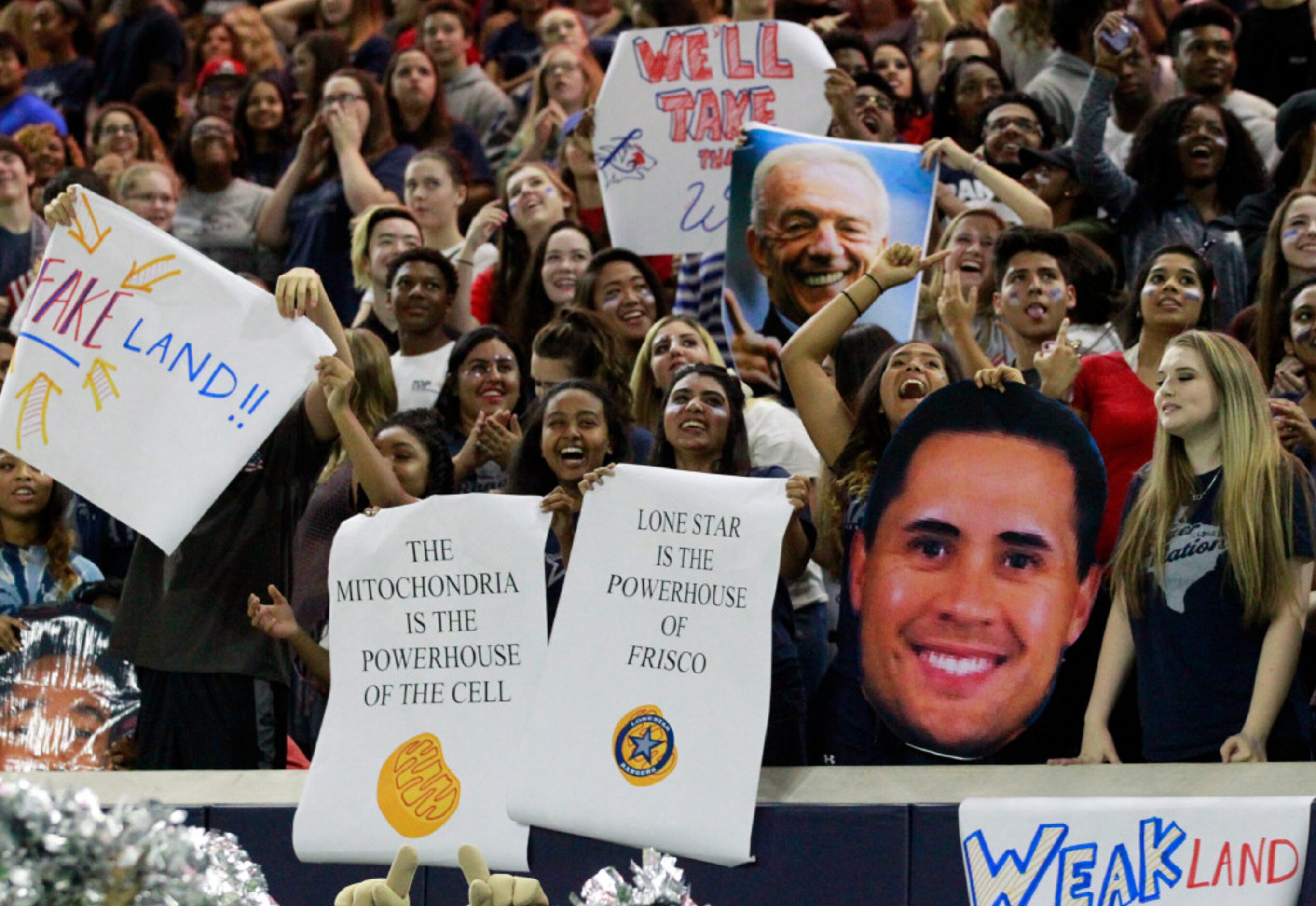 Lone Star High fans wave an eclectic assortment of  signage after the team kicked a field...