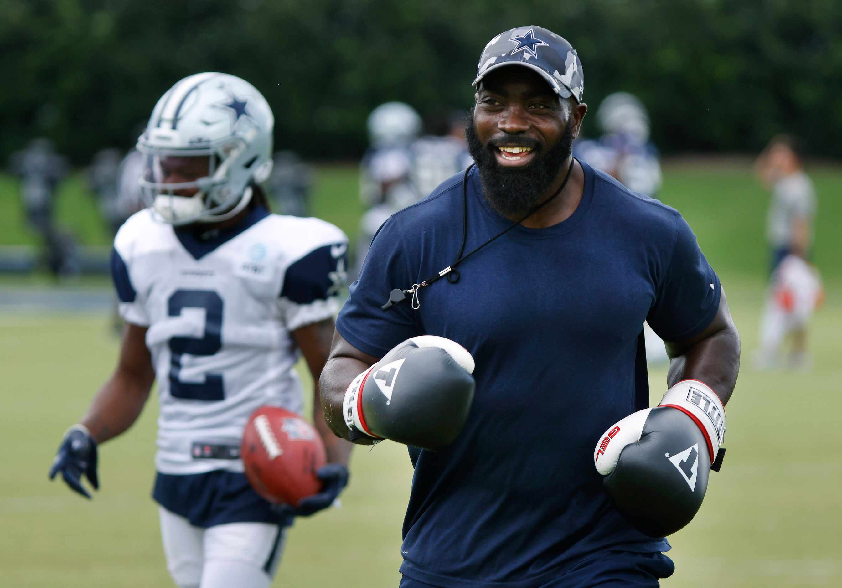 Dallas Cowboys assistant strength and conditioning coach Kendall Smith laughs as he...