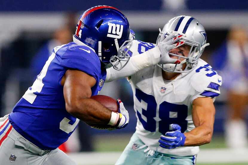 Dallas Cowboys strong safety Jeff Heath (38) receives a hand to the face from New York...
