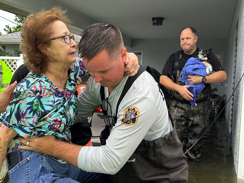 This photo provided by Venice Police Department rescue crews assist residents after ...