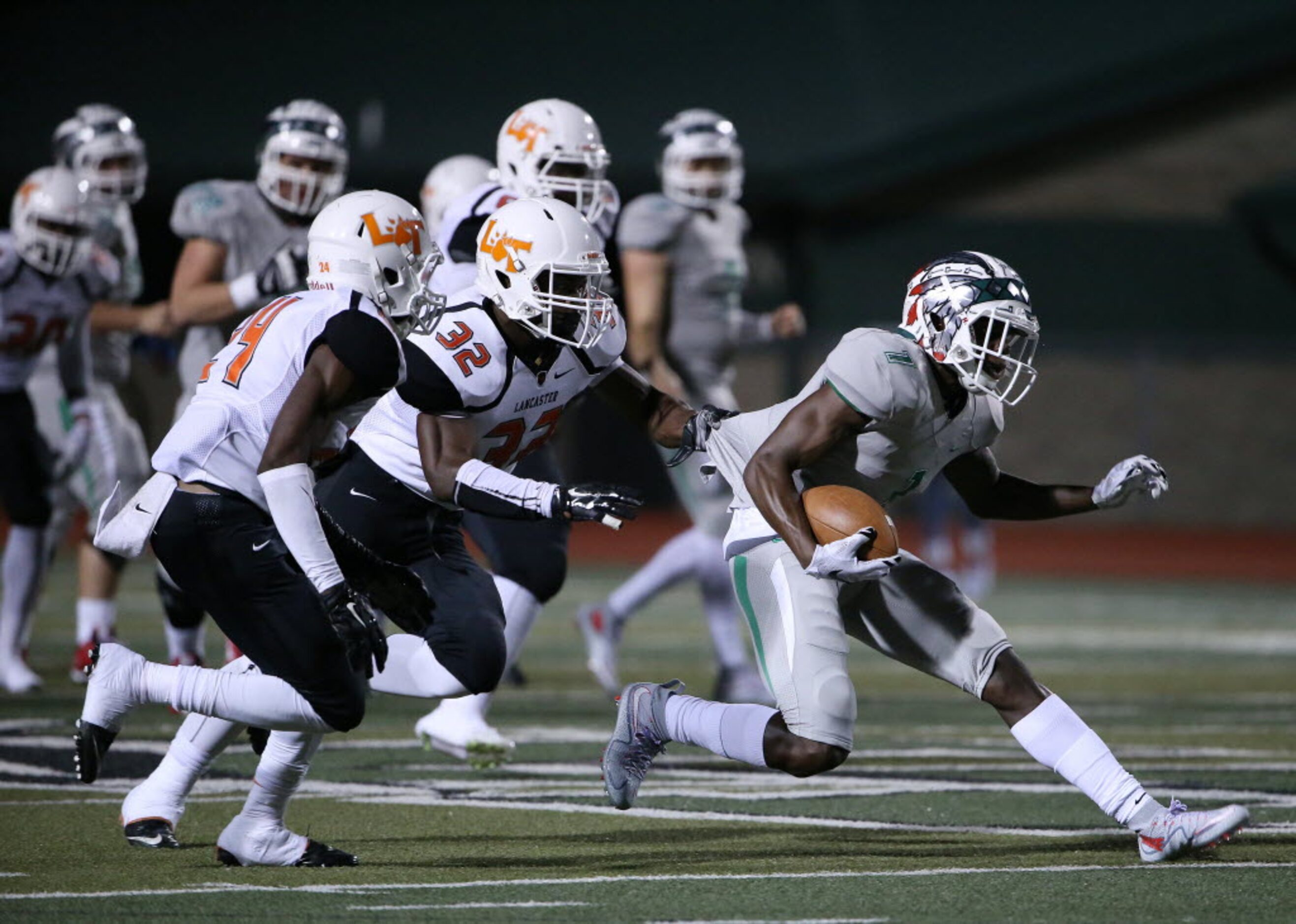 Waxahachie wide receiver Jalen Reagor (1) attempts to avoid a tackle by Lancaster linebacker...