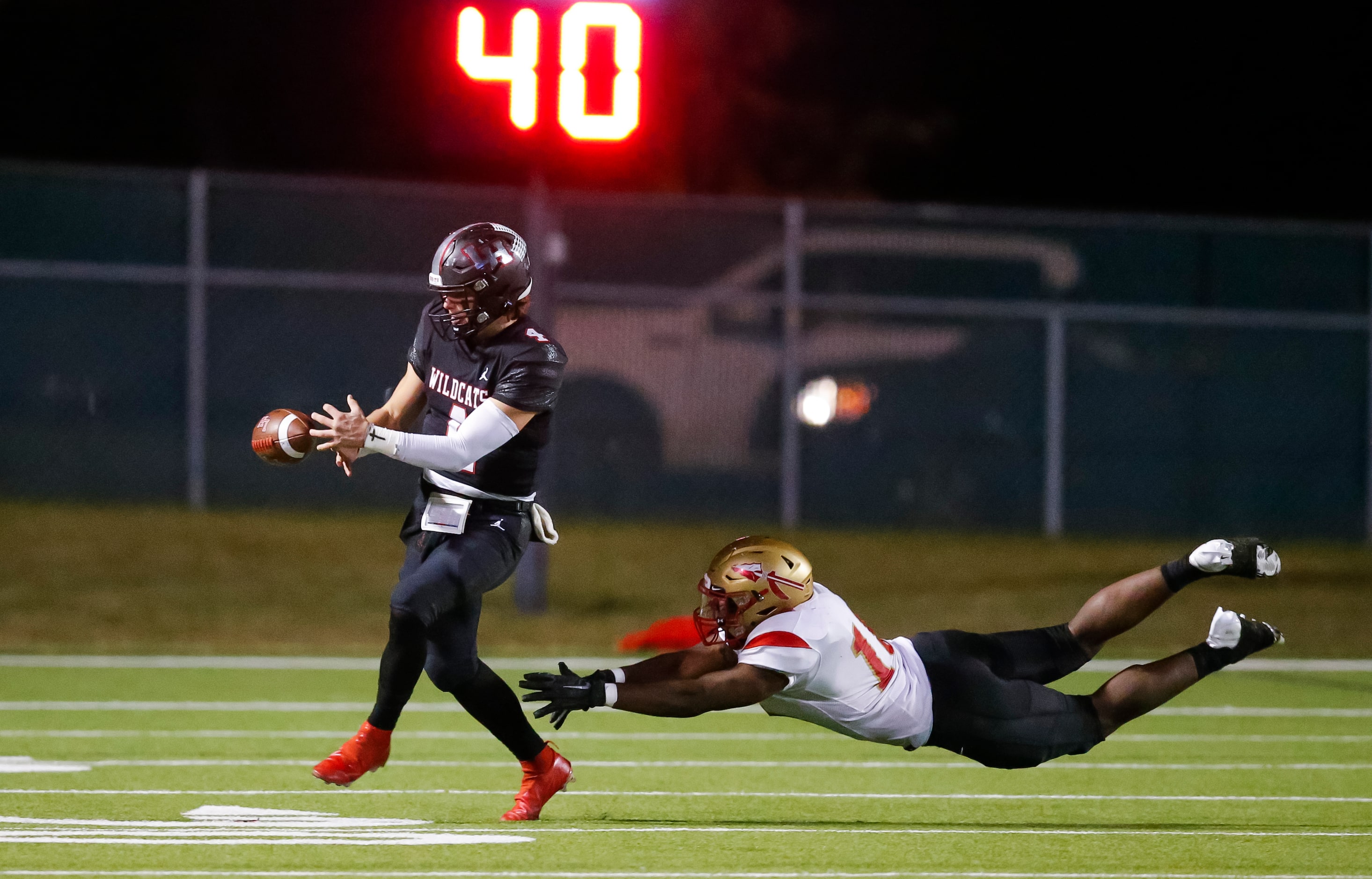 South Grand Prairie senior defensive lineman Silvano Bent, right, attempts to tackle Lake...