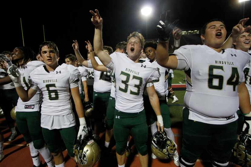Birdville players celebrate following their 24-20 victory over Grapevine. The two teams...