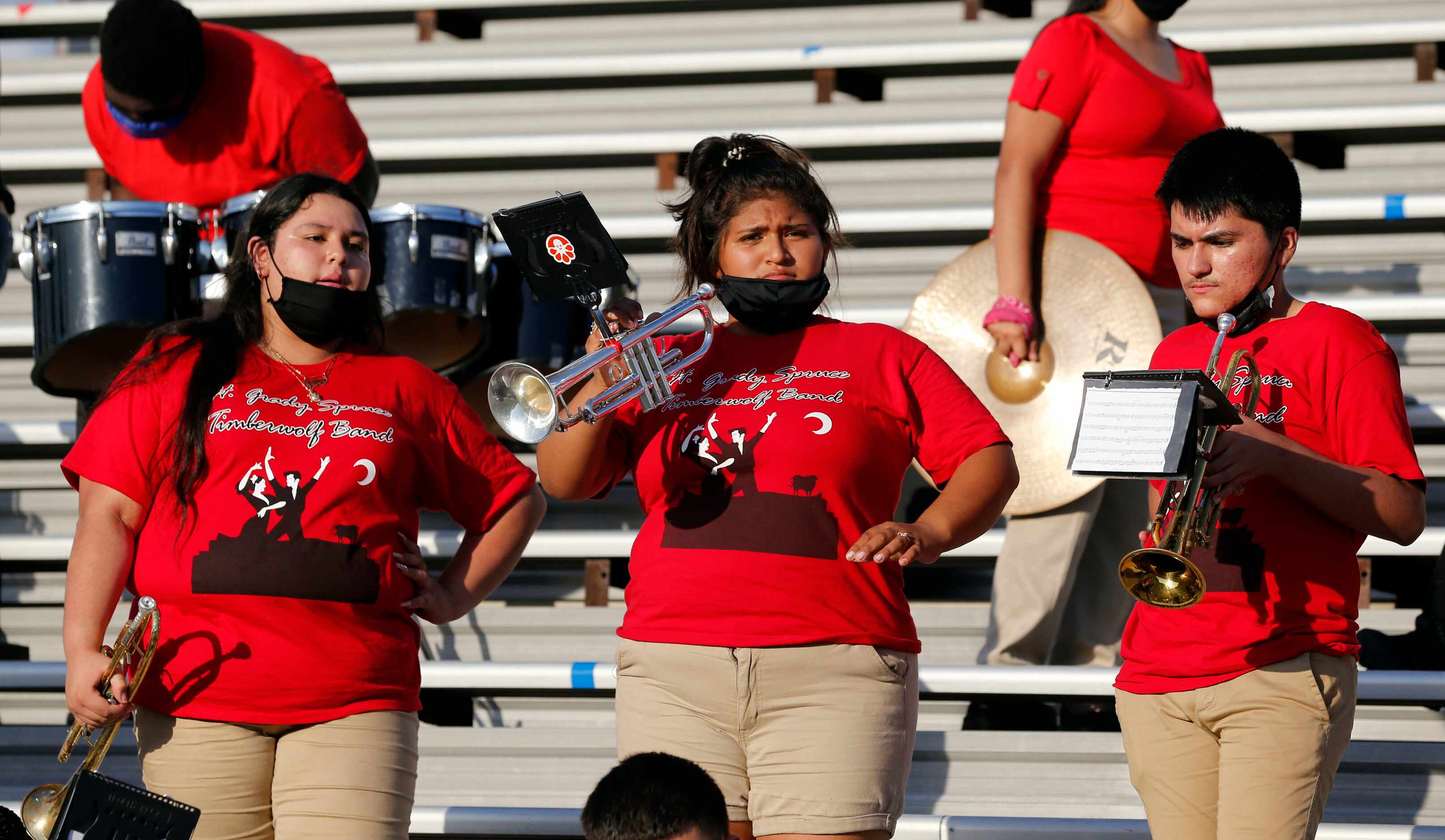 Hot Spruce band members take a break during practice before the start of the first half of...